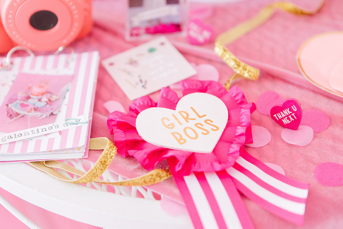 Galentine's Day Party Table covered in pink heart crafts.