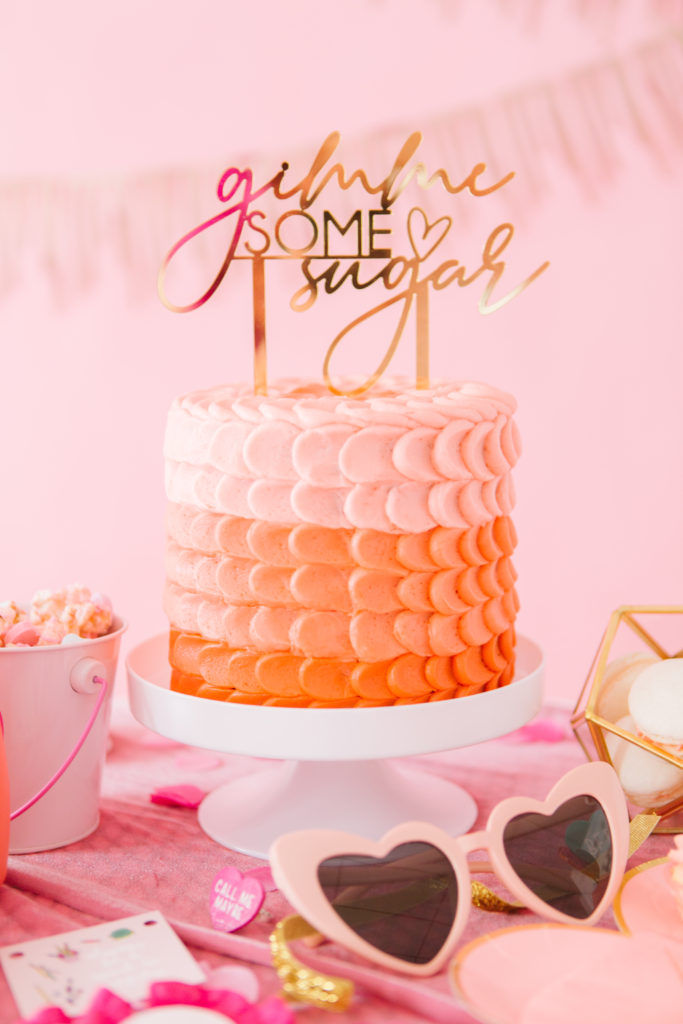 Galentine's Day party decor inspiration featuring ombre cake and gold acrylic "gimme some sugar" cake topper