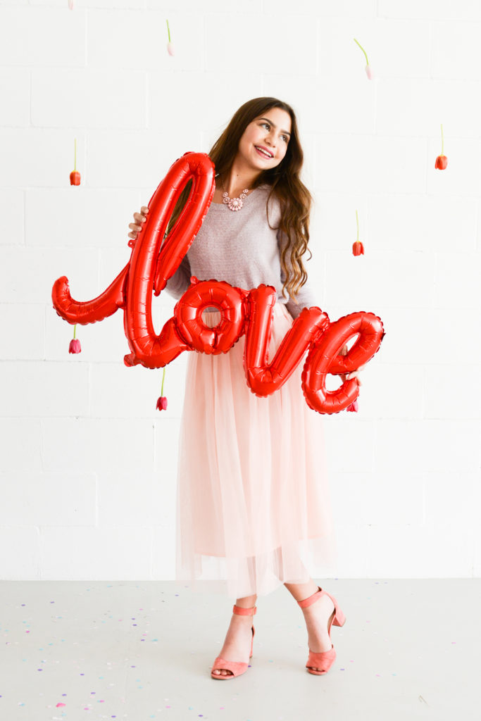 Valentine's Day photo shoot idea featuring love balloon as prop and ombre tulip backdrop