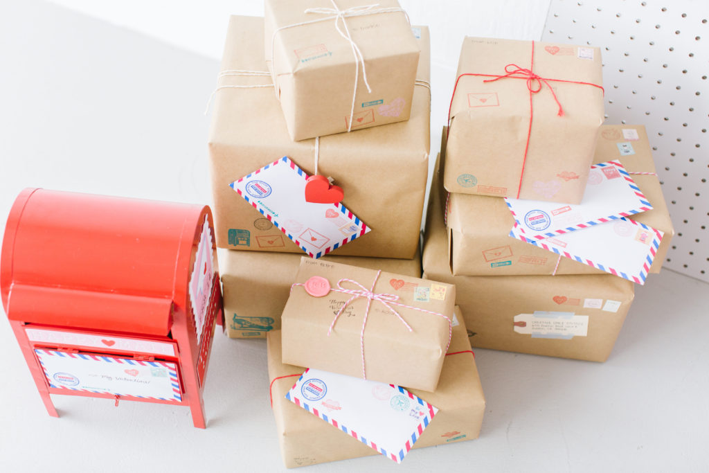 Valentine's Day photo shoot props including air mail envelopes, packages and mailbox