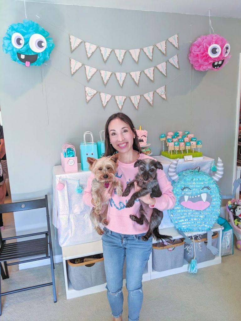 Blaire from Freshly Fuji holding her dogs in front of Terrible Twos Birthday Dessert Table. 