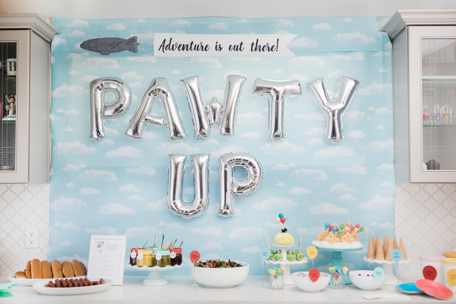 Pixar Up food table with cloud backdrop and "PAWTY UP" balloons