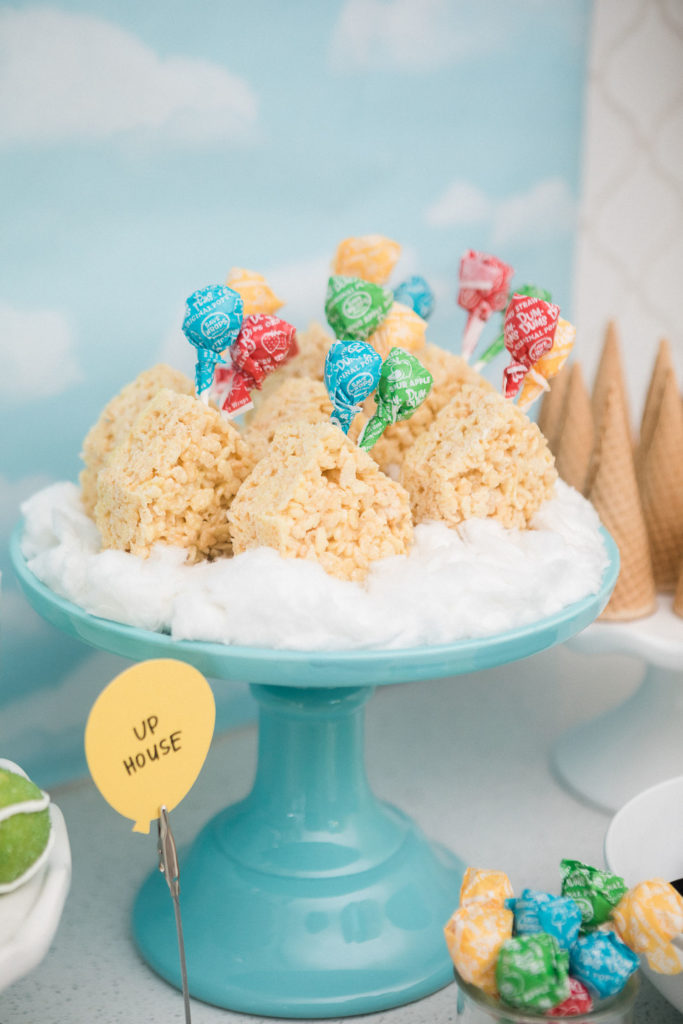 Rice Krispies Treats in the shape of houses with lollipop "balloons"