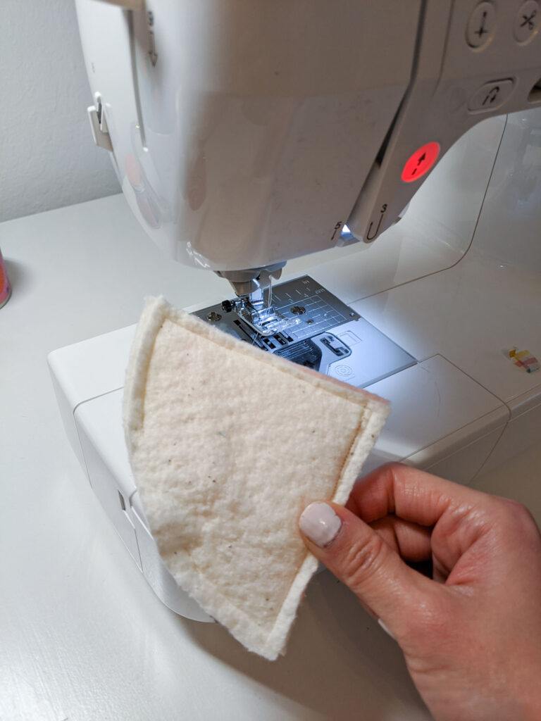 Sewing around each pizza slice, leaving an opening at the rounded edge. 