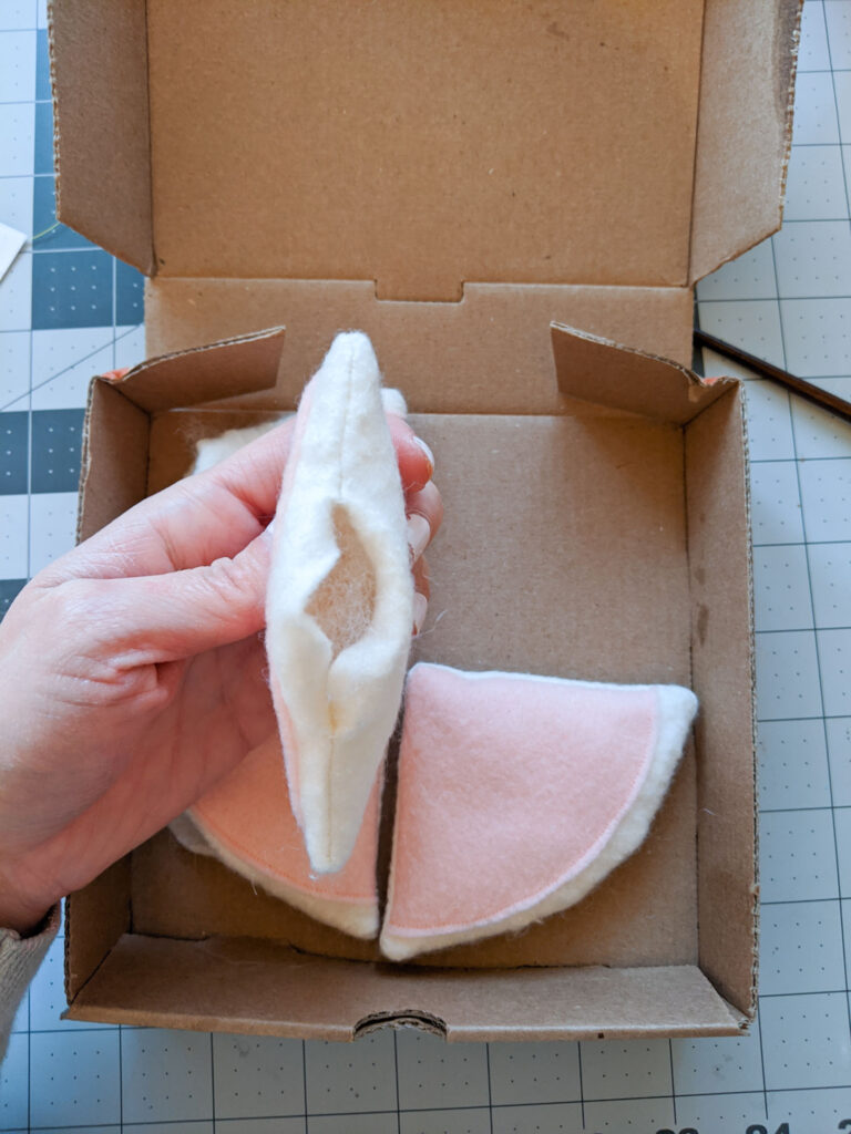 Stuffing each pizza slice with polyester filling.