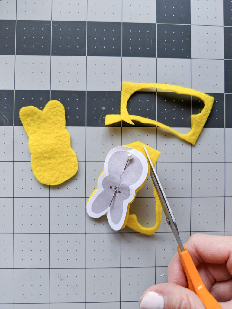Cutting out peeps bunnies out of felt using a paper template.
