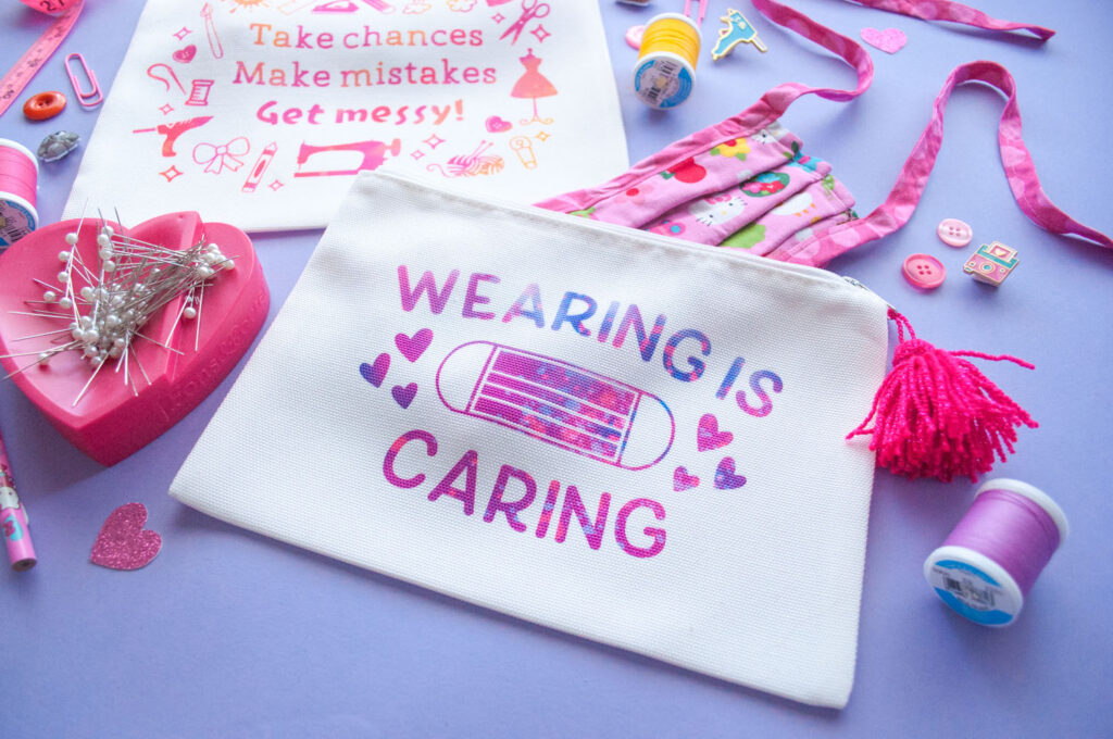Close up of face mask bag made with Cricut Infusible Ink. Design says "Wearing is Caring" with face masks and hearts.