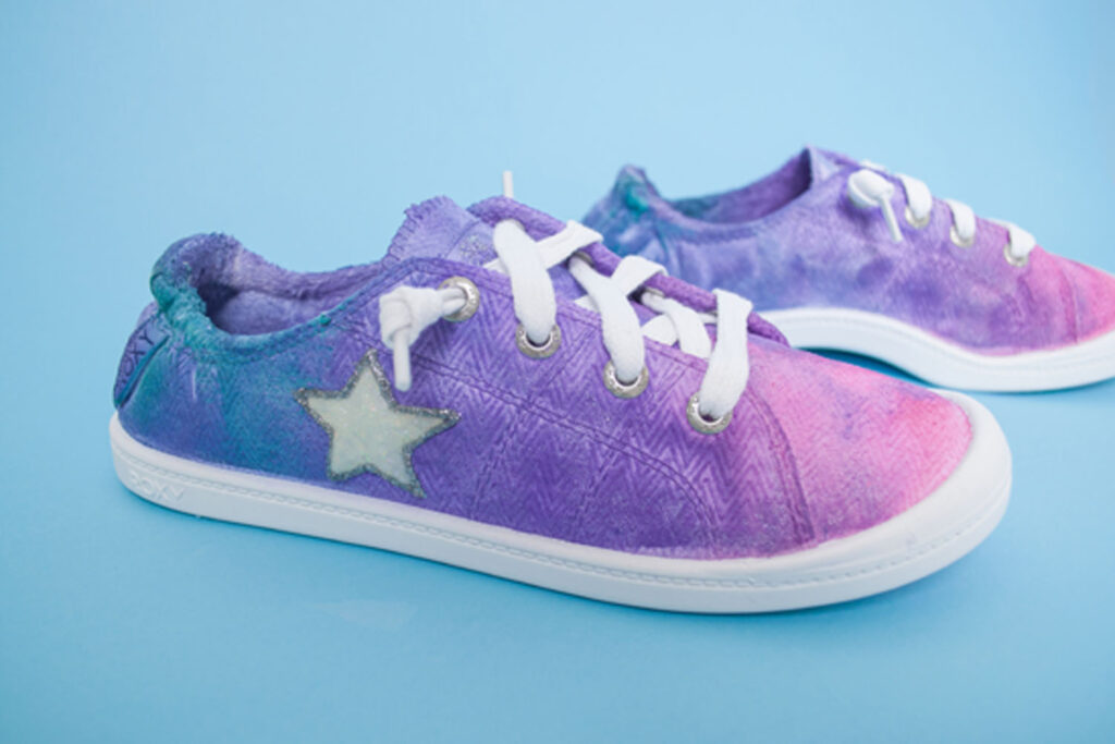 Closeup of tie dyed shoes with 3D glitter star