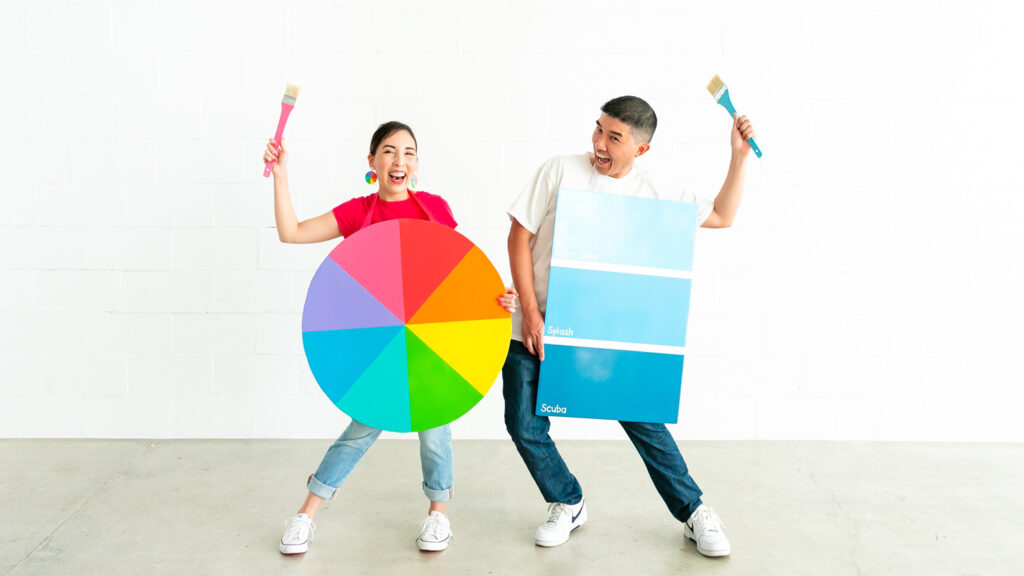 Couple wearing color wheel and paint chip costumes part of colorful family costume.