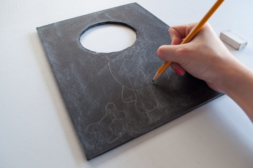 Sketching dog drawing on black foam board