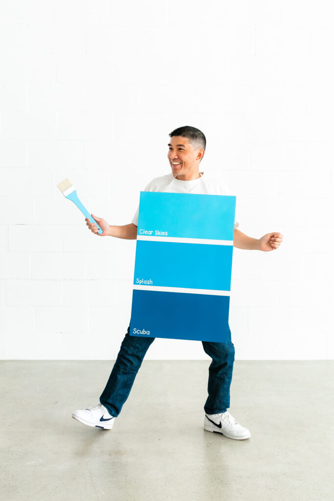 Man dancing in blue paint palette costume