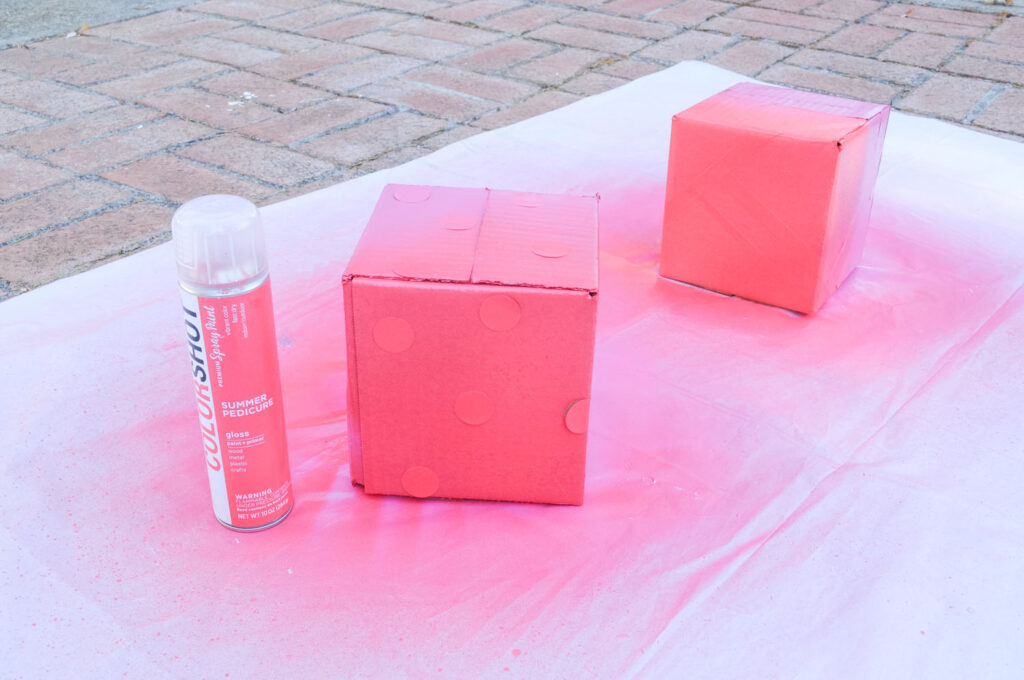 First holiday gift wrap hack - Spray painting over round stickers and washi tape using COLORSHOT Summer Pedicure Spray Paint.