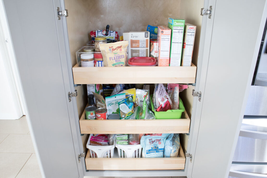 The "before" view of Blaire's pantry. The bottom drawers are overflowing with food items and are not organized in any way.