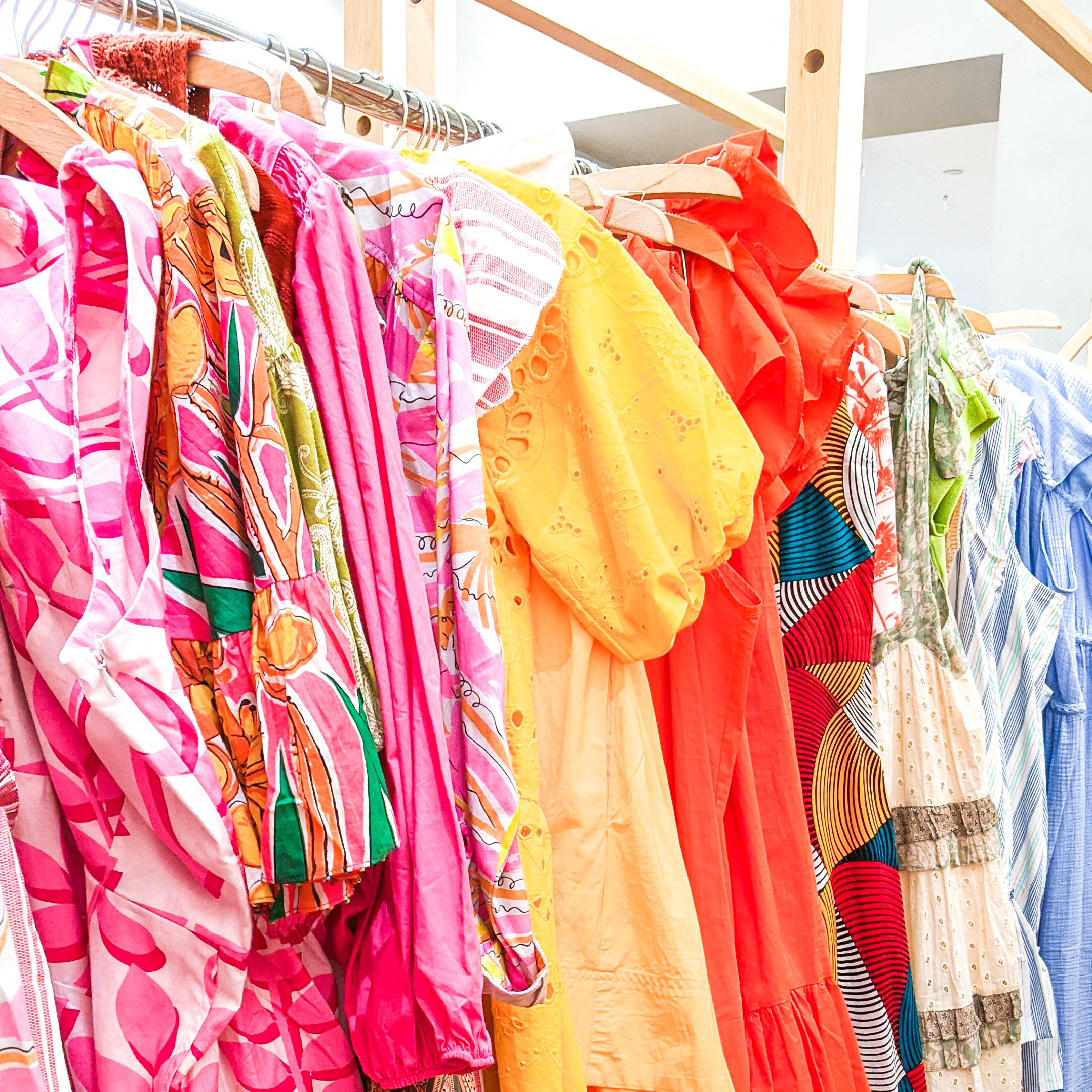 Row of colorful dresses in Anthropologie sales room