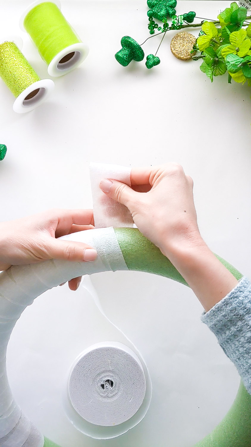 Wrapping white crepe paper streamer around wreath form.