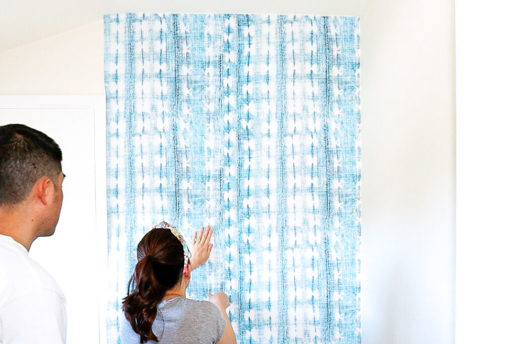 Applying second sheet of wallpaper next to the second sheet.