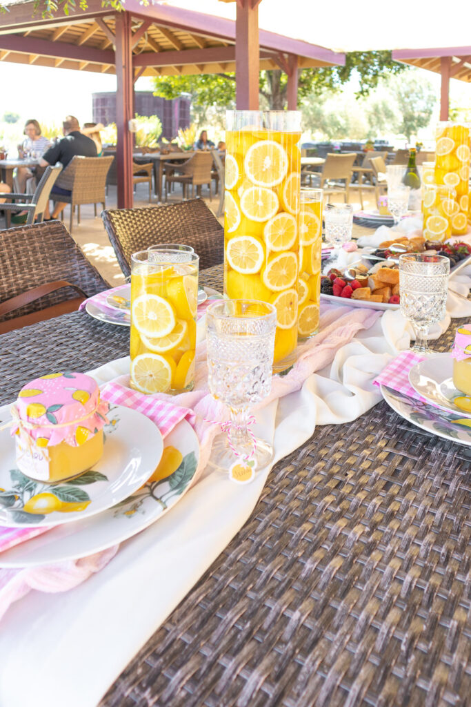 Lemon centerpieces consisted of whole lemons and lemon slices placed into glass cylinder vases and topped with water.