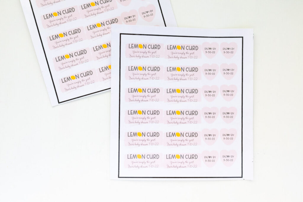 Custom labels created with Cricut Print then Cut feature. There are rectangular labels that say lemon curd and heart labels with the expiration date.