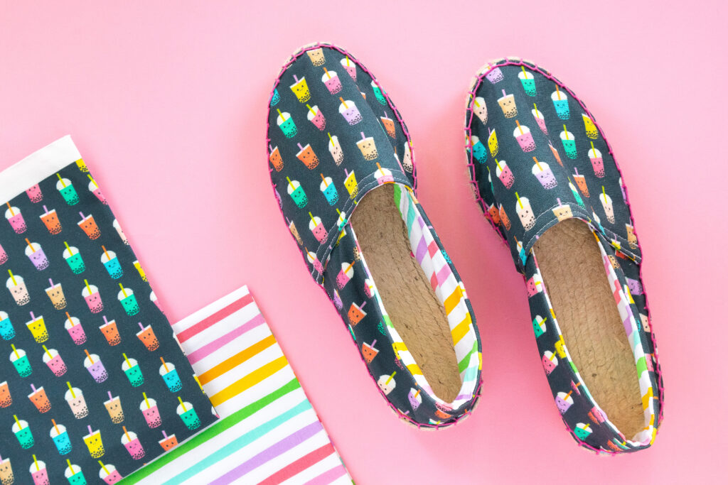 DIY boba print espadrilles with fabric squares on pink background.