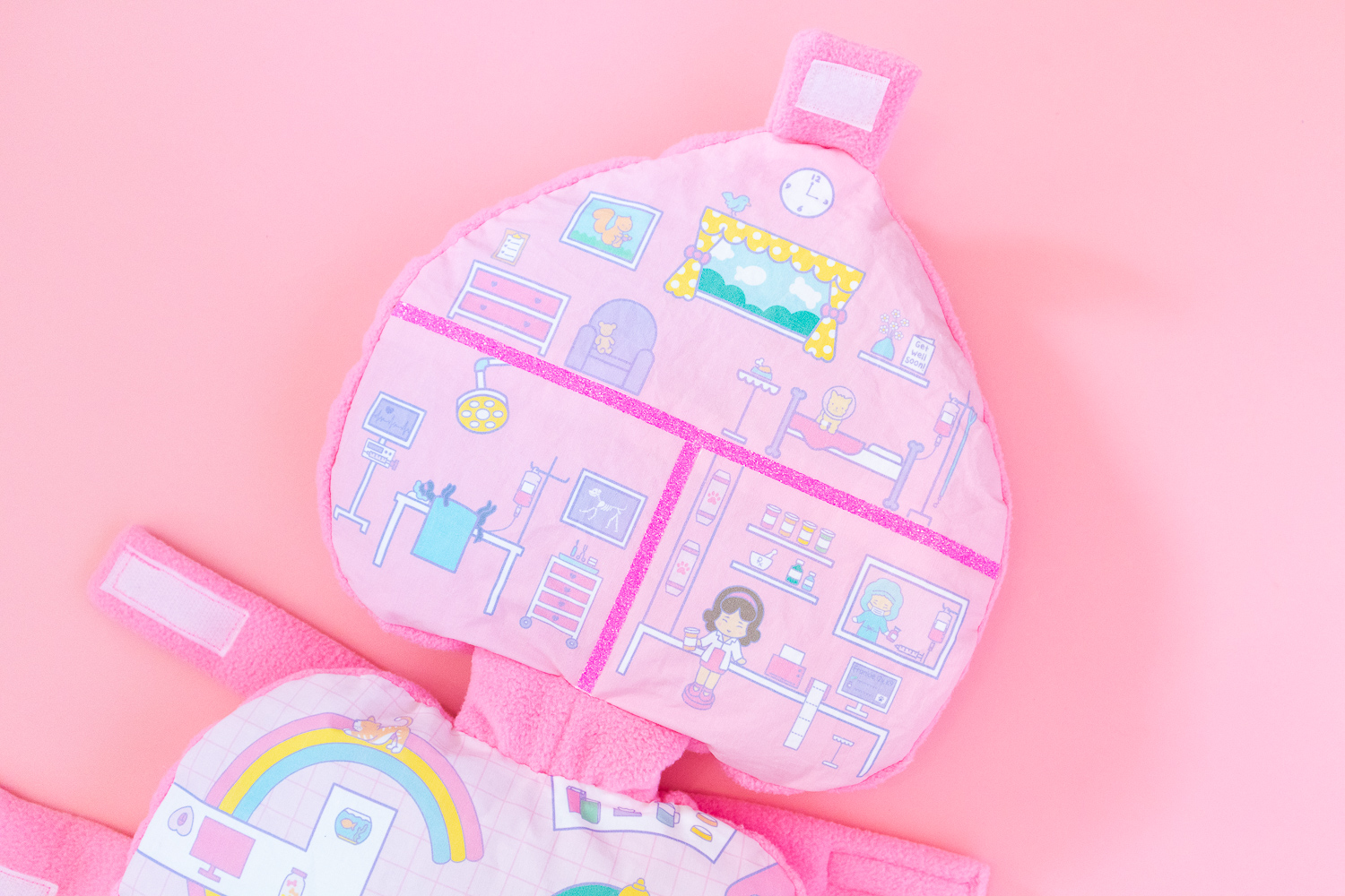 The top half of a Polly Pocket dog costume featuring an illustration of a pet hospital.